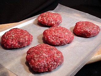 Bison hamburger patties ready for cooling in refrigerator.